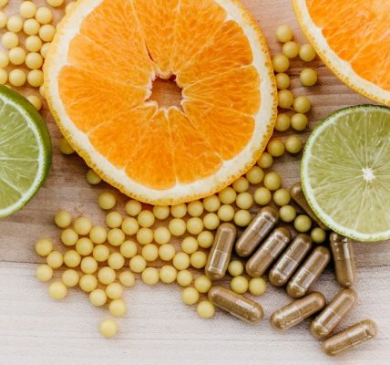 oranges, peas, and limes on a wooden table